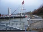 Ein Schiff mit einer Hebeleistung von 200 Tonnen (laut Kranausleger) hebt einen Container der in den Rhein gefallen ist.