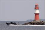 Ein RIB (Festrumpfschlauchboot) prescht am 16.06.2011 am stlichen Molenfeuer in Rostock-Warnemnde vorbei.